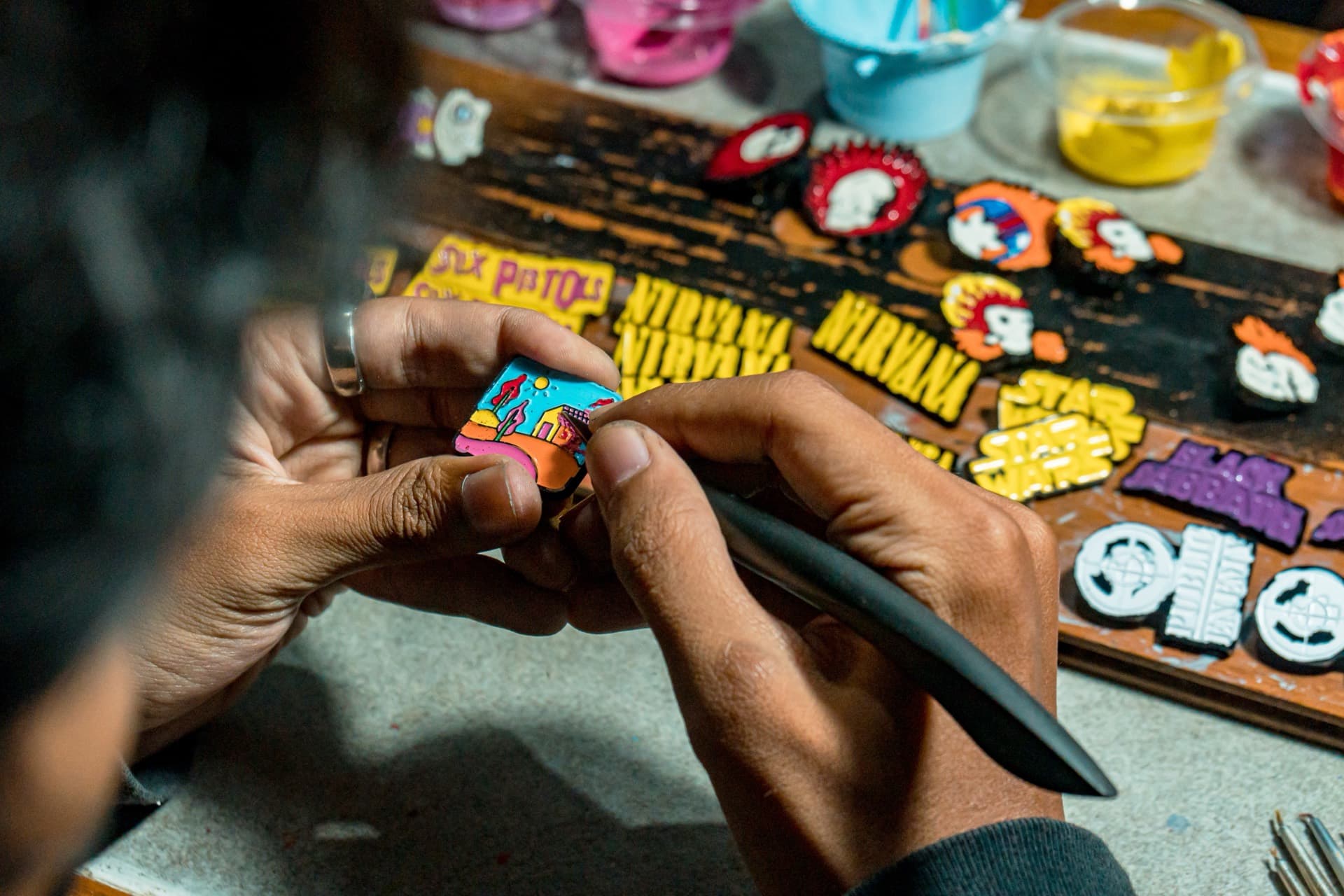 Hand-painted enamel pins in production